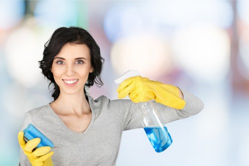 Technician using steam cleaning equipment on upholstered furniture