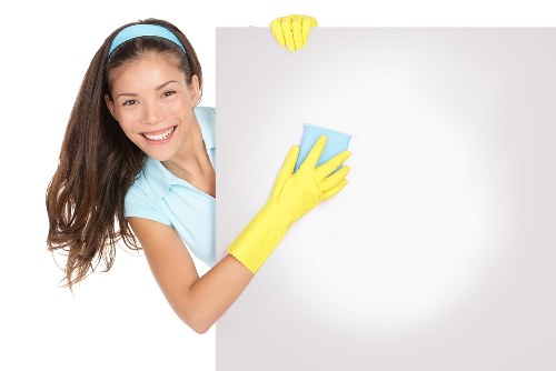 Technician handling carpet cleaning machine with care and correct posture